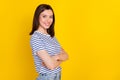 Photo of pretty sweet cheery lady bright grin trendy striped clothes arm folded stand empty space isolated on yellow Royalty Free Stock Photo