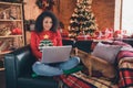 Photo of pretty sweet dark skin woman dressed red sweater showing small friend modern gadget smiling indoors house home