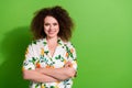 Photo of pretty sweet lady wear print shirt arms folded empty space isolated green color background