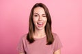 Photo of pretty sweet young woman dressed casual clothes smiling winking showing tongue isolated pink color background