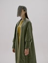 photo pretty woman in a green coat with chain mail on his head unaltered