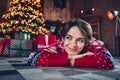 Photo of pretty young girl lying floor dreamy wondered look wear trendy red sweater festive interior living room Royalty Free Stock Photo