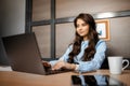 Photo of pretty young manager woman working with laptop in modern office.