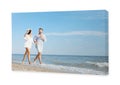 Photo printed on canvas, white background. Happy young couple running together on beach Royalty Free Stock Photo