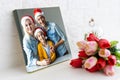 Photo printed on canvas, white background. Happy young family in Santa hats celebrating Christmas at home Royalty Free Stock Photo