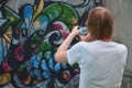 Photo in the process of drawing graffiti on an old concrete wall Royalty Free Stock Photo