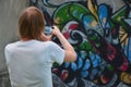 Photo in the process of drawing graffiti on an old concrete wall