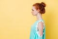 Photo in profile of pretty ginger woman in dress