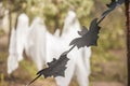 A photo project for Halloween in nature. A garland of black drawn bats against the backdrop of three white ghosts in a forest of g Royalty Free Stock Photo