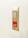 Photo of push lock without key red button mount on electrical cabinet door. Royalty Free Stock Photo