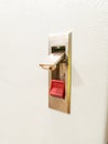 Photo of push lock without key red button mount on electrical cabinet door. Royalty Free Stock Photo