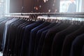 Photo of a rack with suit jackets in a menswear store.