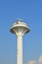 Radar tower or radio lighthouse, blue sky in background Royalty Free Stock Photo