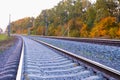 Photo of the railway. Steel rails, concrete sleepers, gravel filling. Autumn urban landscape. Railway landscape