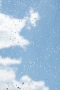 raindrops od window glass with blue sky and white cloud as background Royalty Free Stock Photo