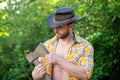 photo of rancher man with axe. rancher with axe. rancher with axe wearing checkered shirt. Royalty Free Stock Photo