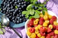 Photo of raspberries and blueberries illuminated by the sun. Delicious yellow and red raspberries on a small saucer. Ye Royalty Free Stock Photo