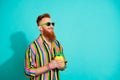 Photo of red hair mustache boyfriend wear striped shirt drink ananas juice looking empty space pub club isolated on cyan Royalty Free Stock Photo