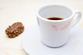 A photo of the red lipstick marks on your coffee cup. Dirty empty white porcelain cup on the plate and a chocolate candy. Messthet Royalty Free Stock Photo