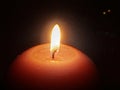 Red candle in the dark close-up