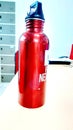 Photo of a red water bottle on the office desk