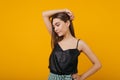 Photo of refined brown-haired girl on orange background. Studio portrait of stunning serio