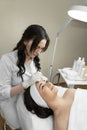 The photo reflects the therapeutic procedure of deep cleansing of the skin of the face, during which a beautiful woman