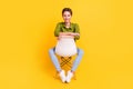 Photo of relaxed cute dream lady sit chair enjoy rest pause wear green shirt isolated yellow color background