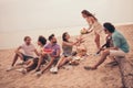 Photo of relaxed positive group buddies picnic gathering share watermelon wear casual outfit nature seaside beach