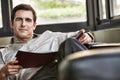 Relaxed successful businessman sitting on sofa while reading Royalty Free Stock Photo