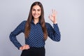 Photo of reliable cute business lady show okey gesture wear dotted blouse isolated grey color background