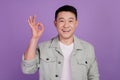 Photo of reliable funny korean man show okey fingers well done gesture isolated violet color background