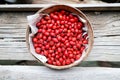 Ripe rosehips or wild rose berries on a natural wooden background Royalty Free Stock Photo