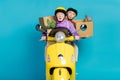 Photo of retired grey haired pensioner couple biker ride hold box move house amazed husband wife isolated on blue color Royalty Free Stock Photo