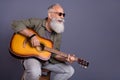 Photo of retired man eyewear bar guitarist performance curious look empty space isolated over grey color background