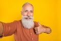 Photo of retired man make selfie show thumb-up select suggest good ad isolated over yellow color background