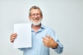 Photo of retired old man holding a sheet of paper copy-space posing  background Royalty Free Stock Photo