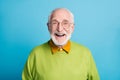 Photo of retired old man open mouth shiny smile excited wear glasses green pullover isolated blue color background Royalty Free Stock Photo