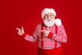 Photo of retired old man white beard direct finger empty space suggest interesting solution wear santa x-mas costume
