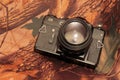 Photo of retro camera on the camouflage