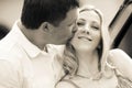 Happy husband kissing his wife with a newborn baby Royalty Free Stock Photo