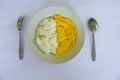 a photo rice with fried egg omelet, with spoon and fork on white plate. isolated on wood background. breakfast with omelet in. Royalty Free Stock Photo