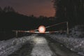 Photo of road barrier with no vehicles sign on the road at night. Gate barrier on the forest road in winter Royalty Free Stock Photo