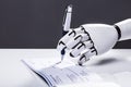 Robot Signing Cheque Royalty Free Stock Photo