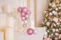 Photo of romantic holiday interior design, traditional Christmas tree, white candles, luxury silver and pink balls as