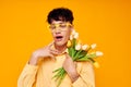 Photo of romantic young boyfriend in yellow glasses with a bouquet of flowers Lifestyle unaltered Royalty Free Stock Photo