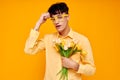 Photo of romantic young boyfriend in yellow glasses with a bouquet of flowers Lifestyle unaltered Royalty Free Stock Photo