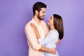 Photo of romantic young couple hug look each other dream date day wear orange shirt blue sweater isolated on violet Royalty Free Stock Photo