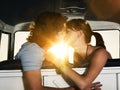 Romantic young couple kissing in campervan Royalty Free Stock Photo