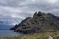 Photo of a rugged mountain jutting into the sea